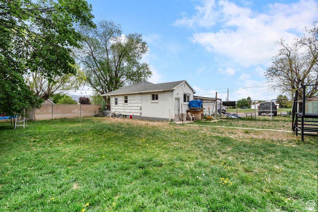 Rear view of house with a trampoline