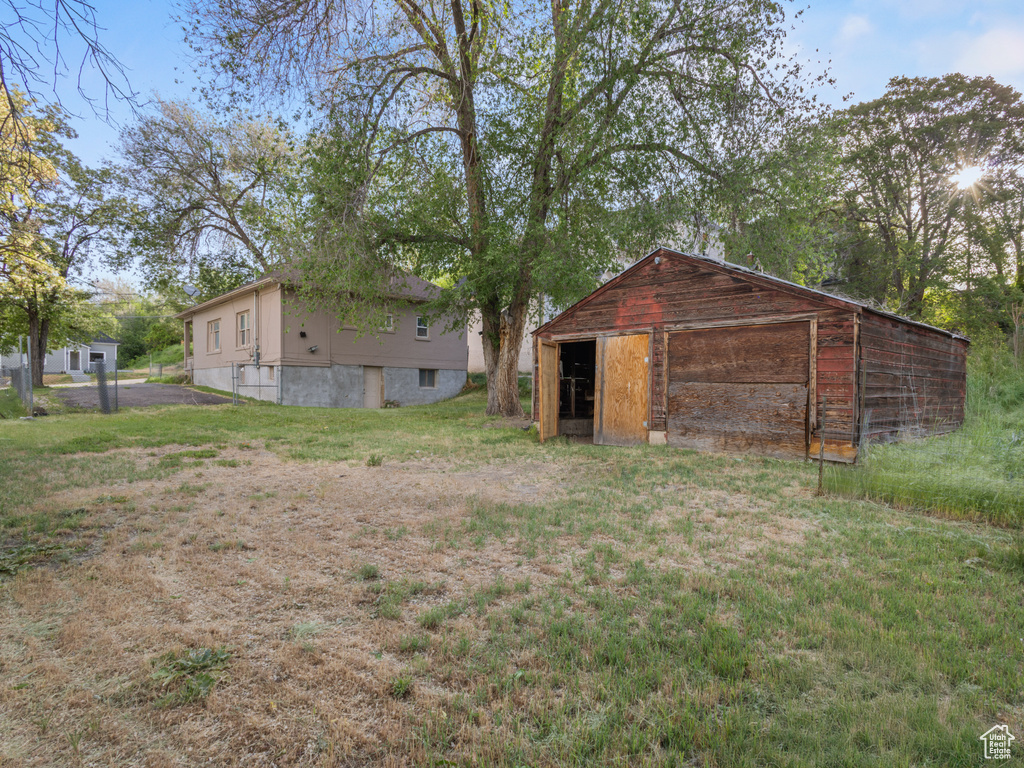 View of pole building with a yard