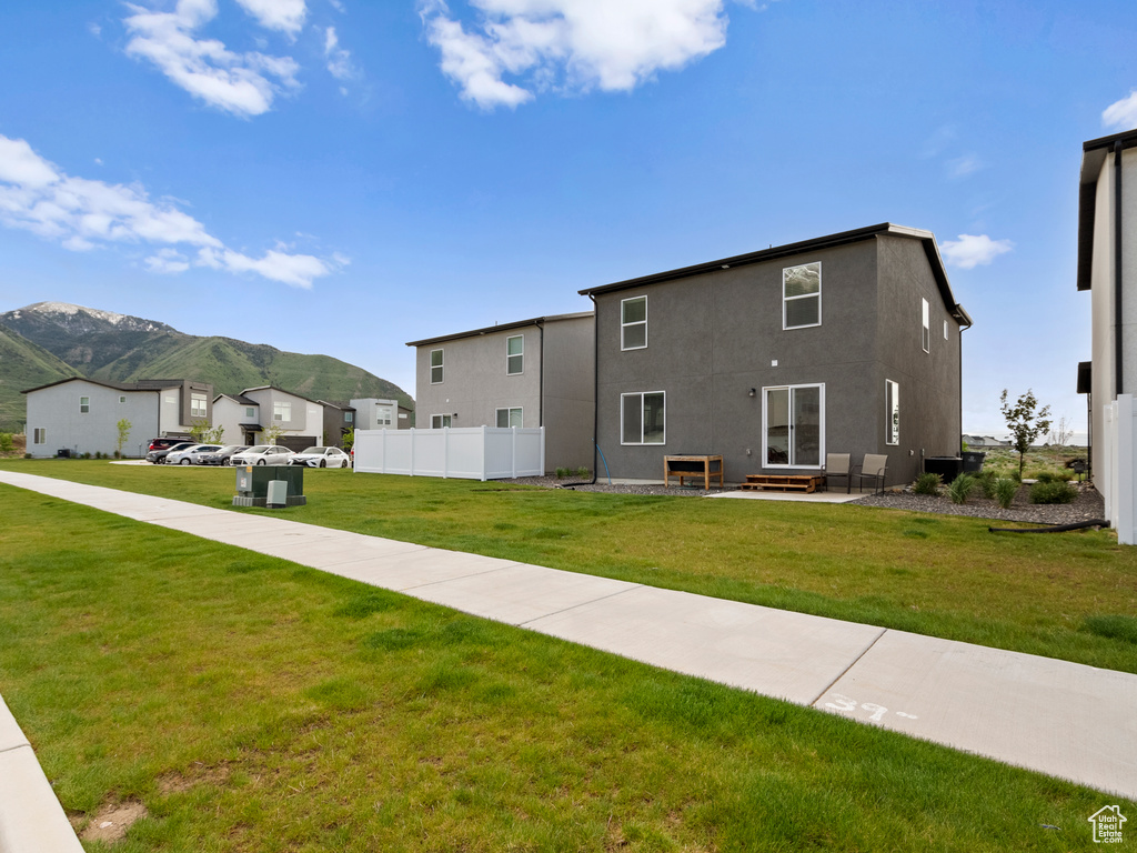 Rear view of property featuring a mountain view, stucco siding, a residential view, and entry steps