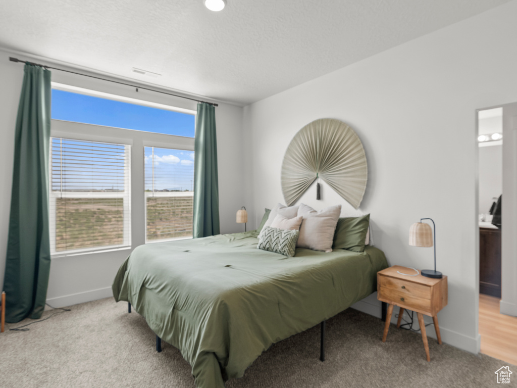 Carpeted bedroom featuring baseboards