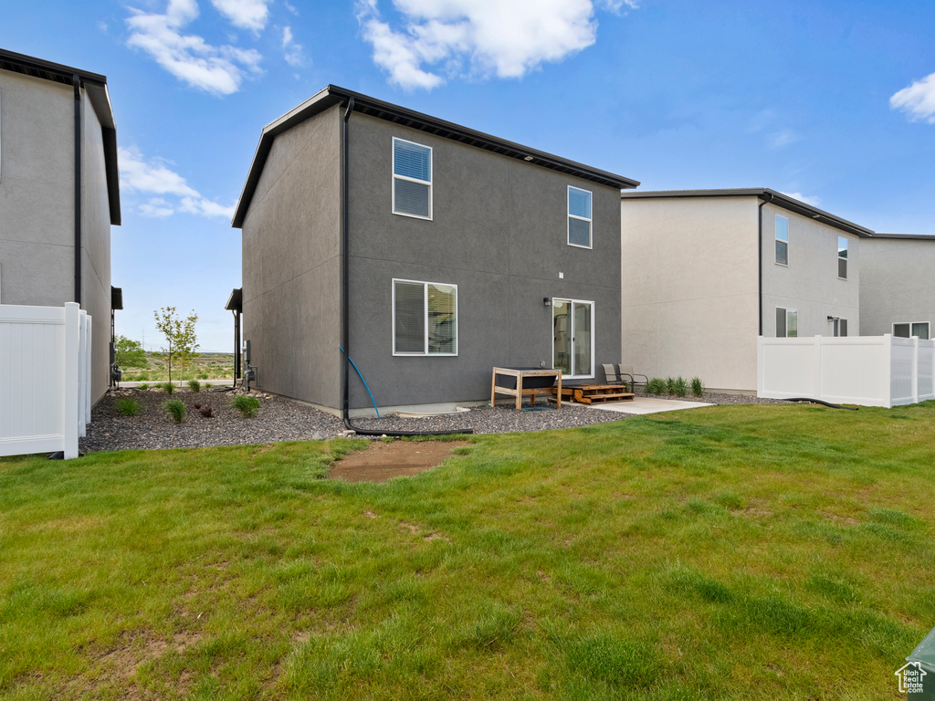 Rear view of property featuring stucco siding