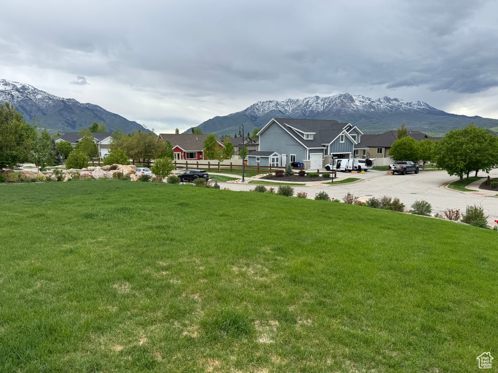 View of community with a mountain view, a residential view, and a lawn