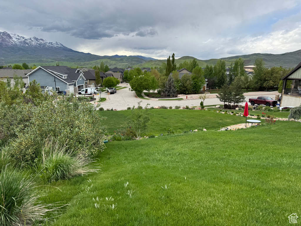 View of mountain backdrop featuring nearby suburban area