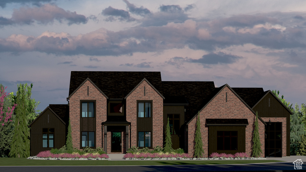 View of front of property with board and batten siding and brick siding