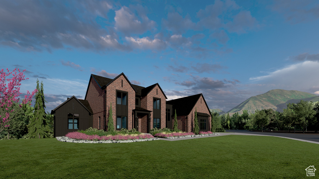 View of front facade featuring brick siding, a front lawn, and a mountain view