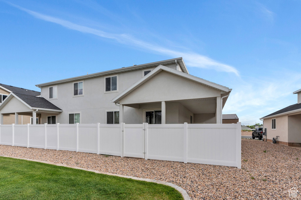 Back of property with fence and stucco siding