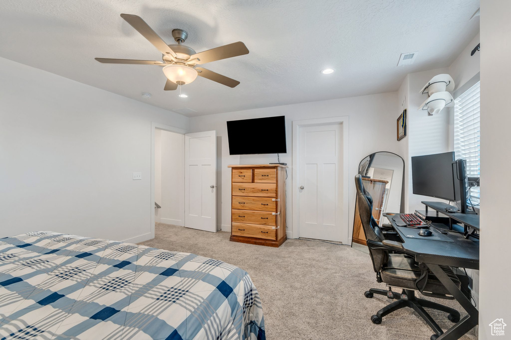 Bedroom featuring light carpet, recessed lighting, ceiling fan, an office area, and baseboards