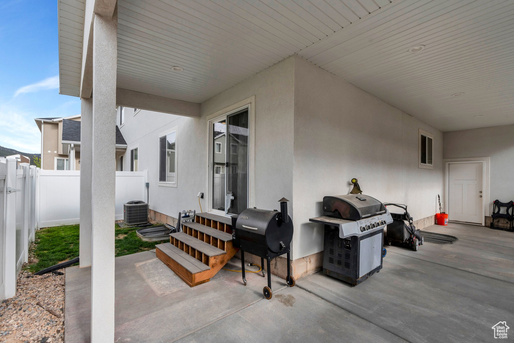 View of patio / terrace featuring entry steps, area for grilling, fence, and central air condition unit