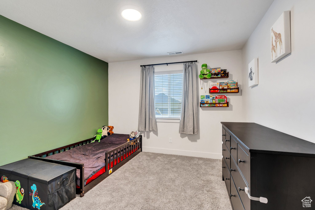 Carpeted bedroom featuring baseboards