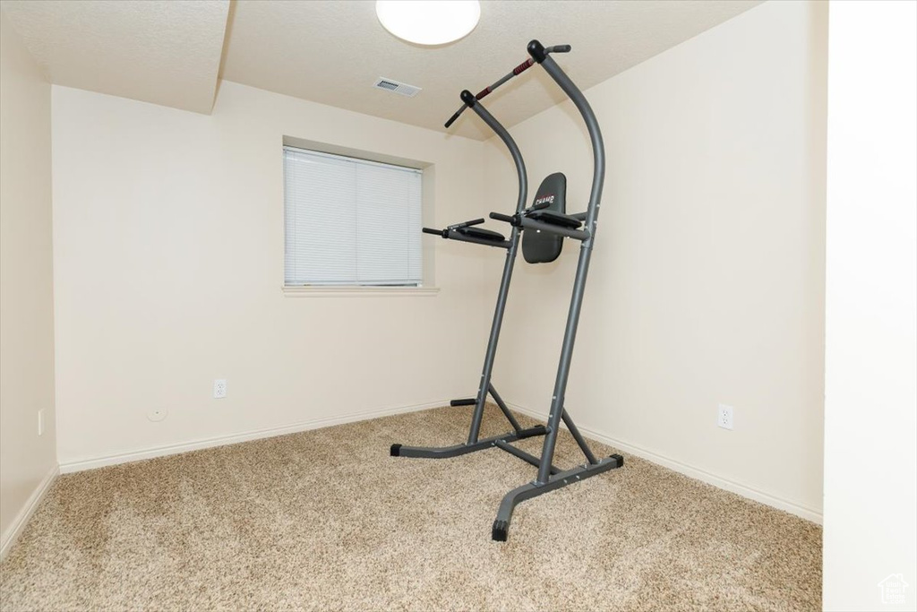 Workout area featuring carpet and baseboards