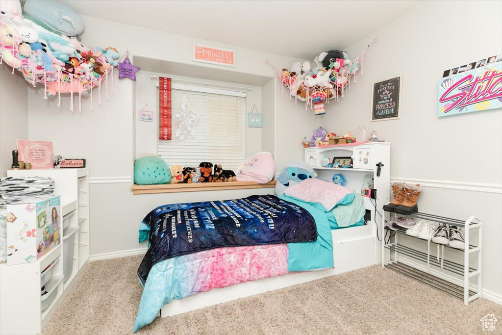 Bedroom featuring carpet floors and baseboards