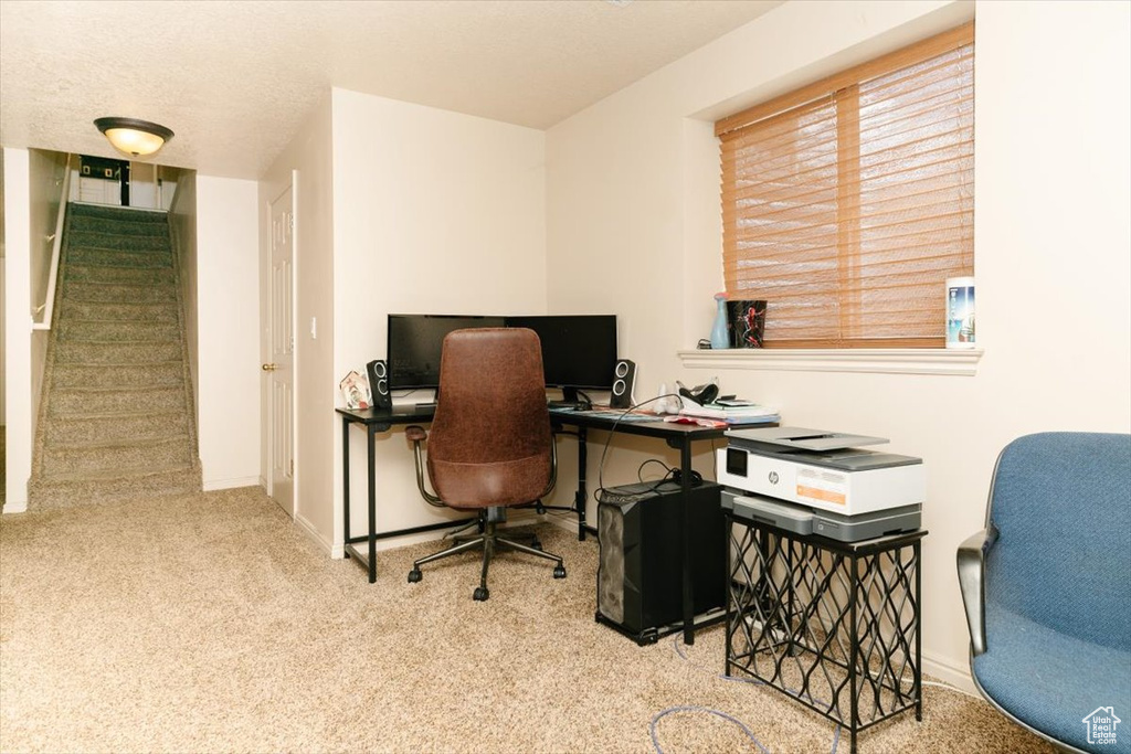 Carpeted office space featuring baseboards