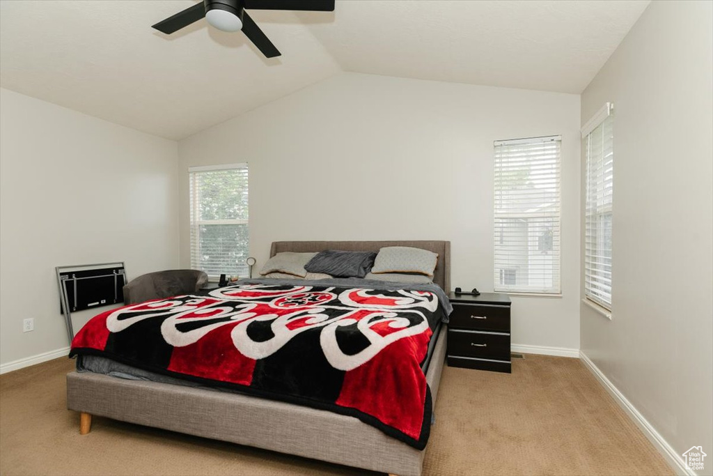 Bedroom with carpet flooring, vaulted ceiling, baseboards, and ceiling fan