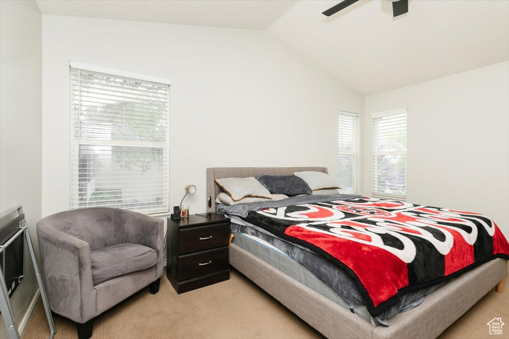 Bedroom featuring light carpet and lofted ceiling