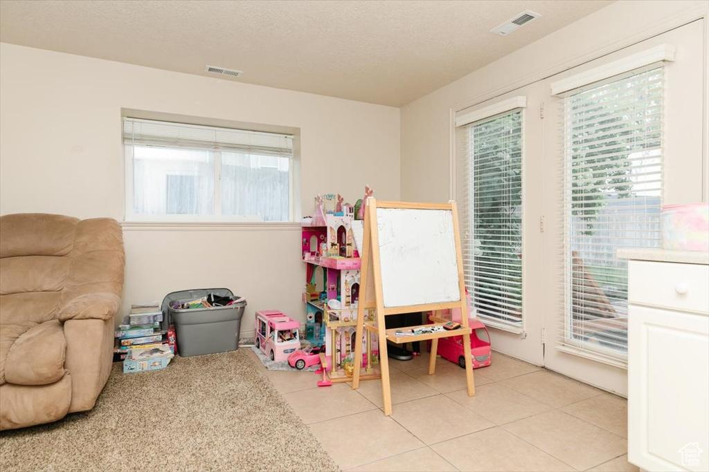 Rec room with plenty of natural light and light tile patterned floors