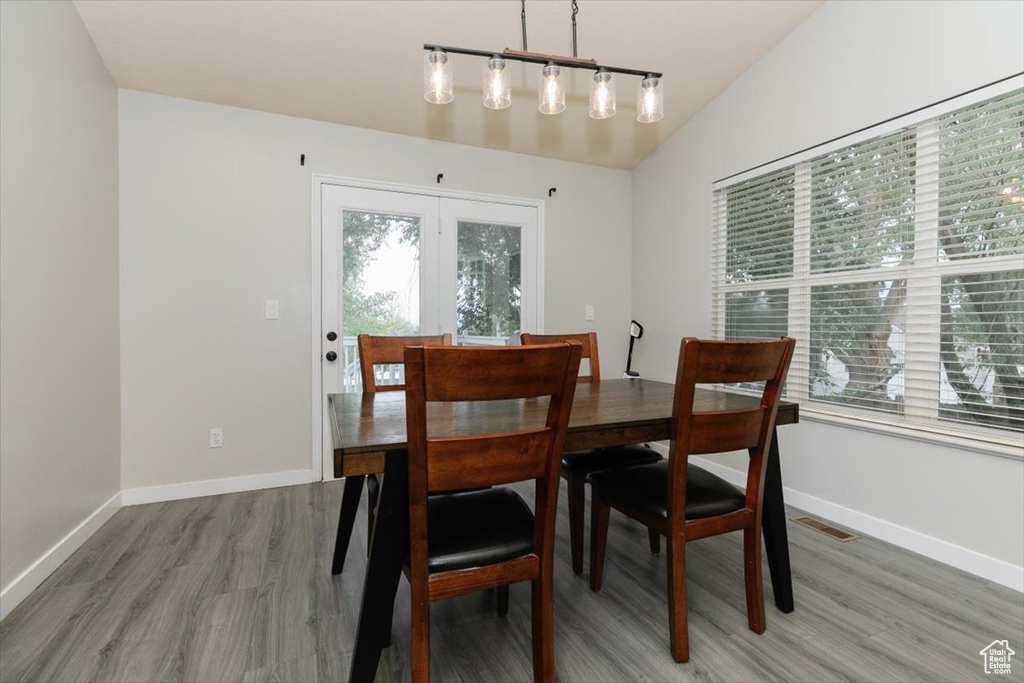 Dining area featuring wood finished floors, rail lighting, and baseboards