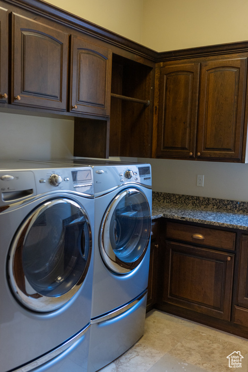 Laundry area with cabinet space and washing machine and dryer