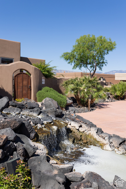 Exterior view of stucco siding, fence, and a gate