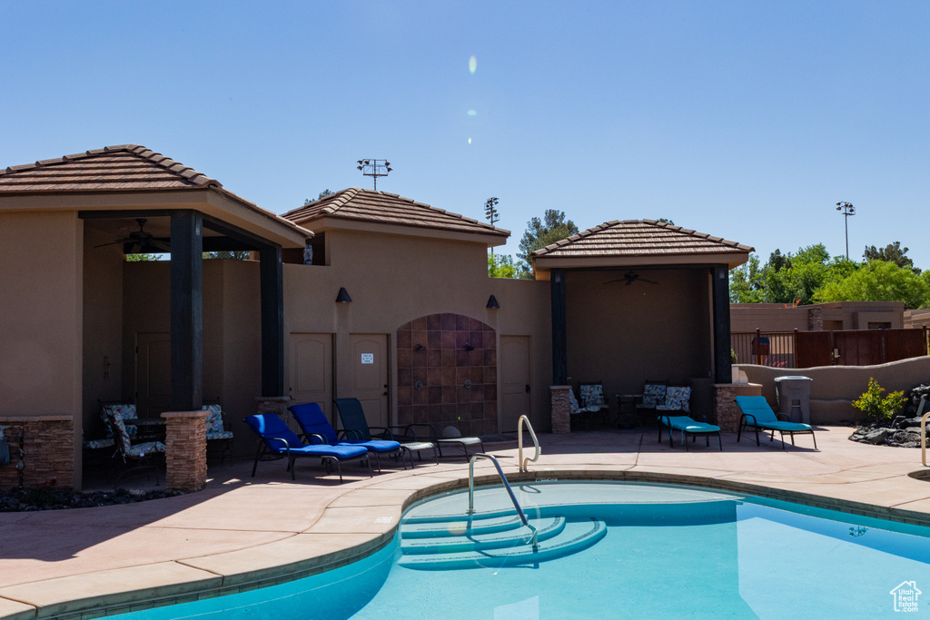 View of pool with a ceiling fan, a patio area, fence, and a gazebo