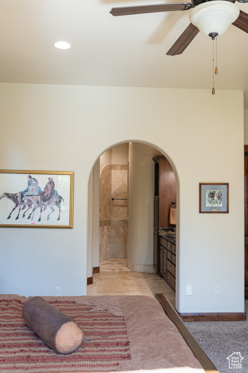 Bedroom featuring arched walkways, a ceiling fan, and recessed lighting