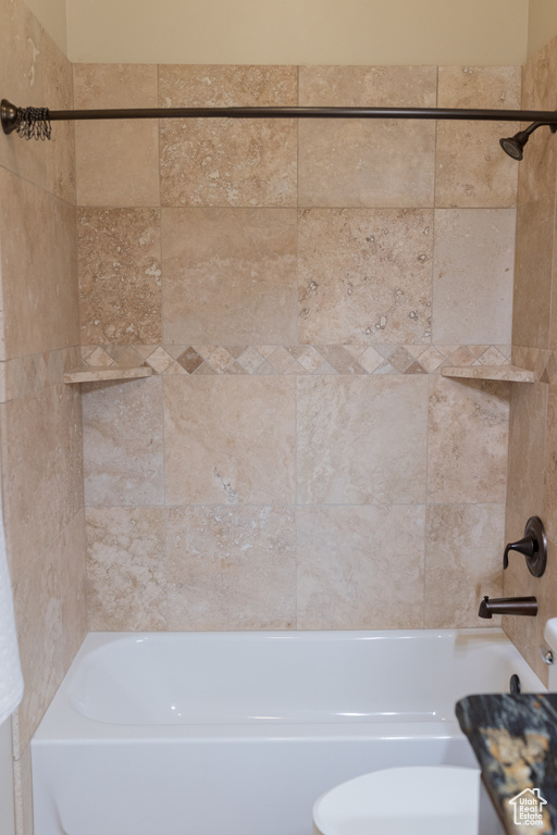 Bathroom with toilet and bathing tub / shower combination