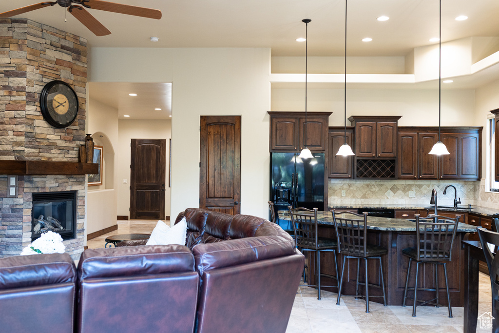 Living room featuring ceiling fan, recessed lighting, and a fireplace