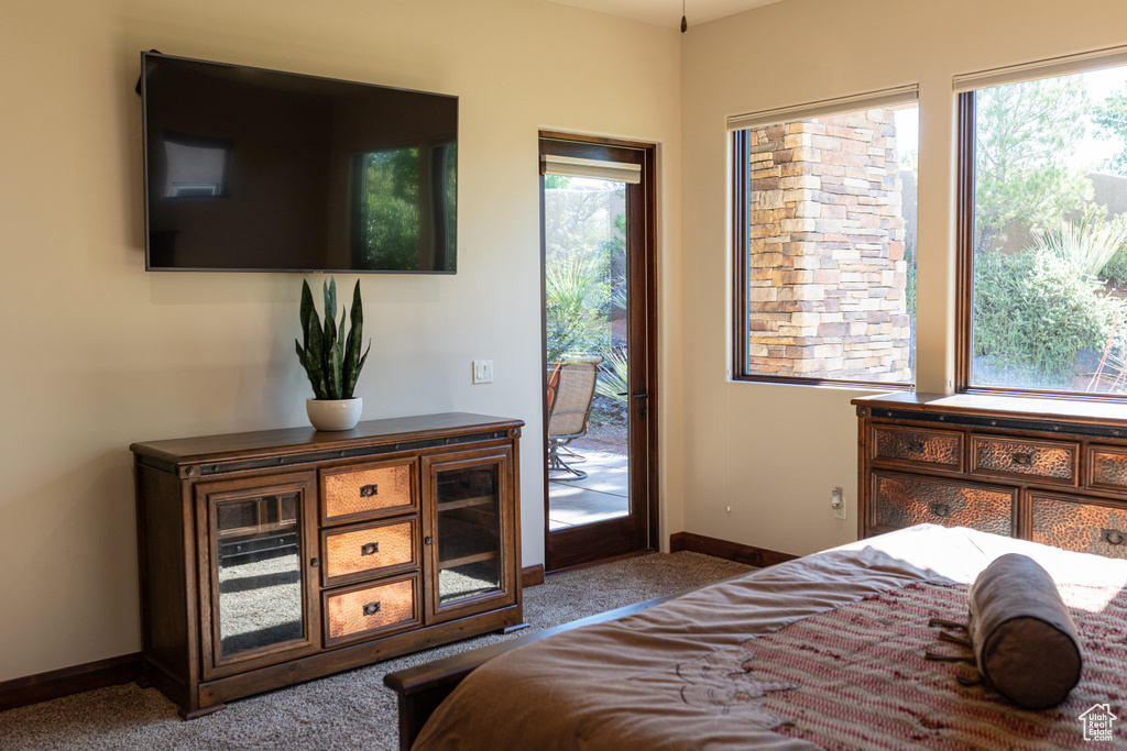 Bedroom featuring access to outside, carpet, and baseboards