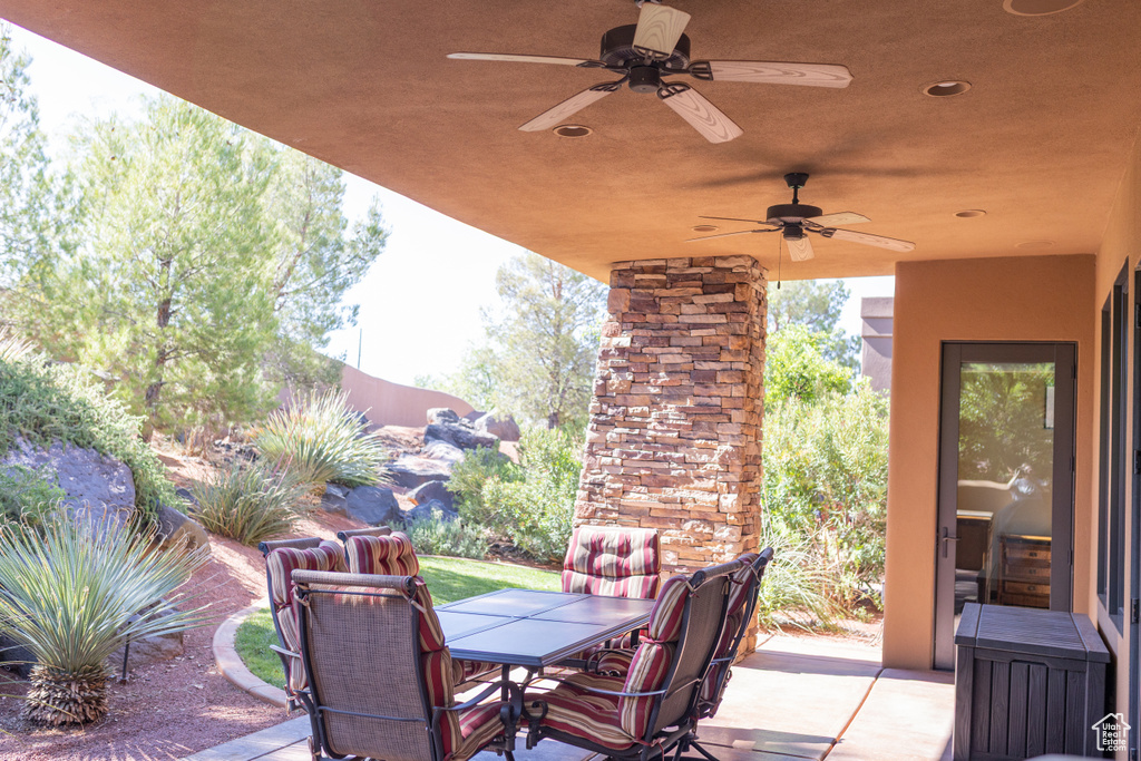 View of patio with a ceiling fan and outdoor dining area