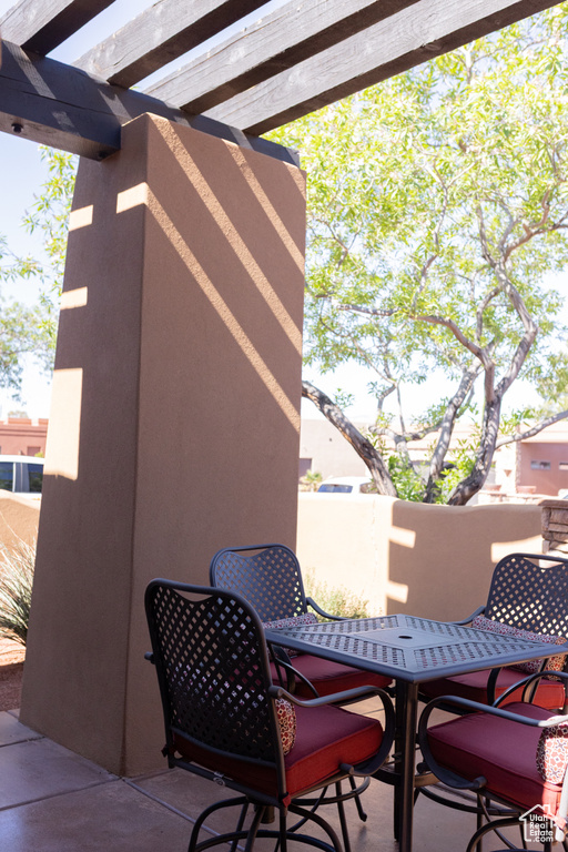 View of patio with outdoor dining area and a pergola