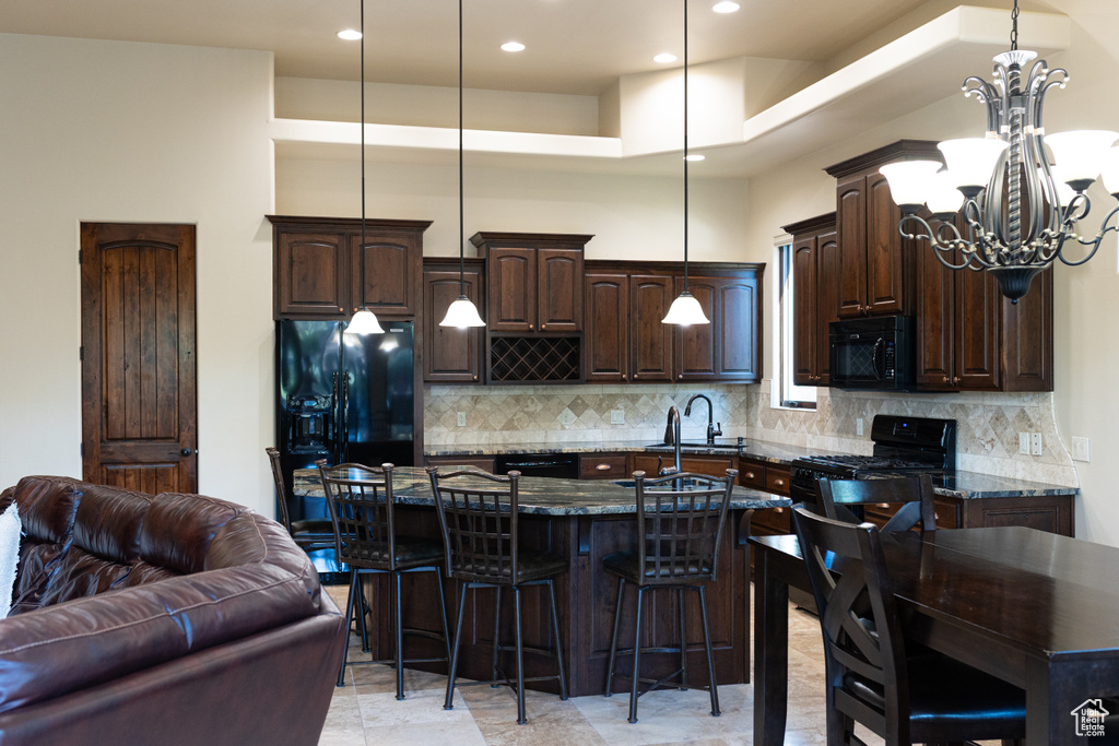 Kitchen featuring black appliances, a sink, dark brown cabinetry, a chandelier, and recessed lighting