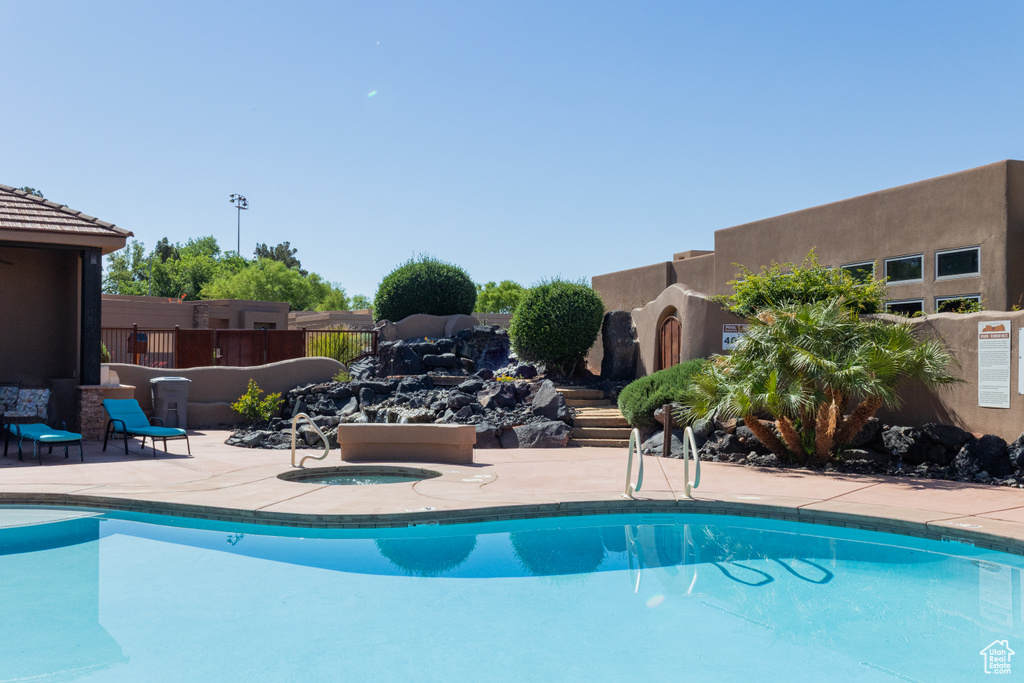 Community pool with a community hot tub, a patio area, and fence