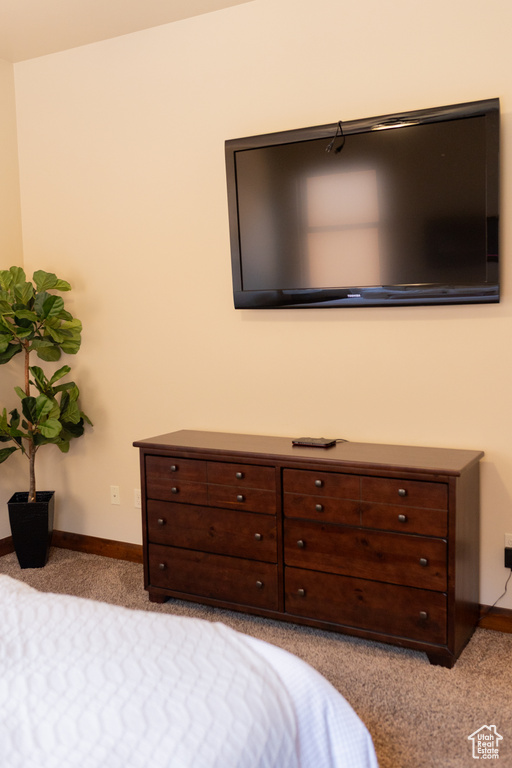 Bedroom featuring light colored carpet and baseboards