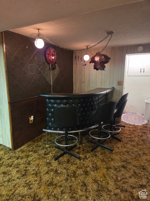 Dining room featuring a dry bar and wooden walls
