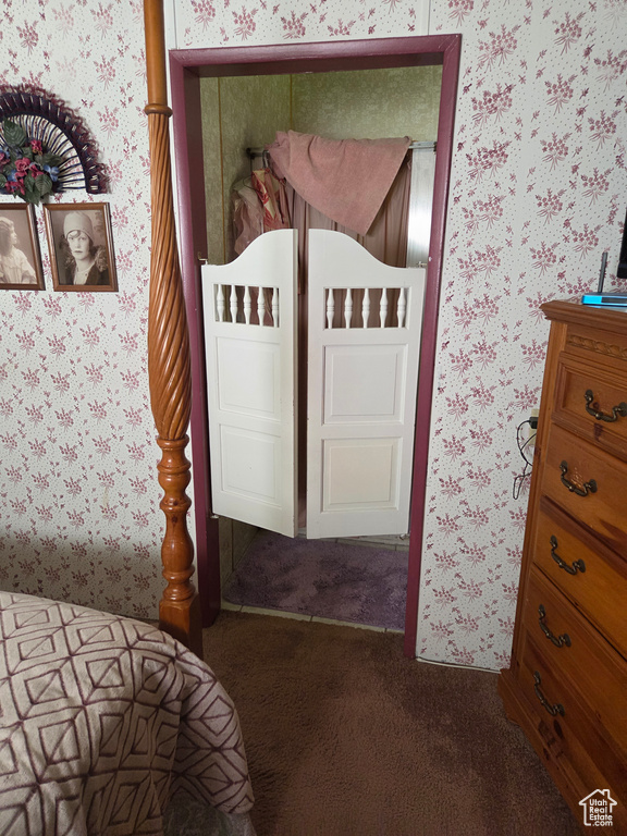 Carpeted bedroom with wallpapered walls