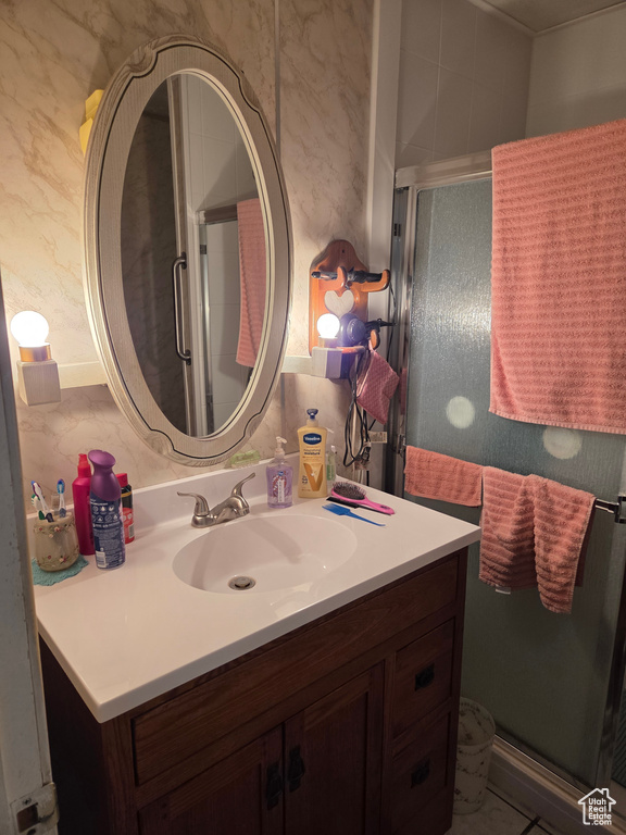 Bathroom with vanity and a stall shower