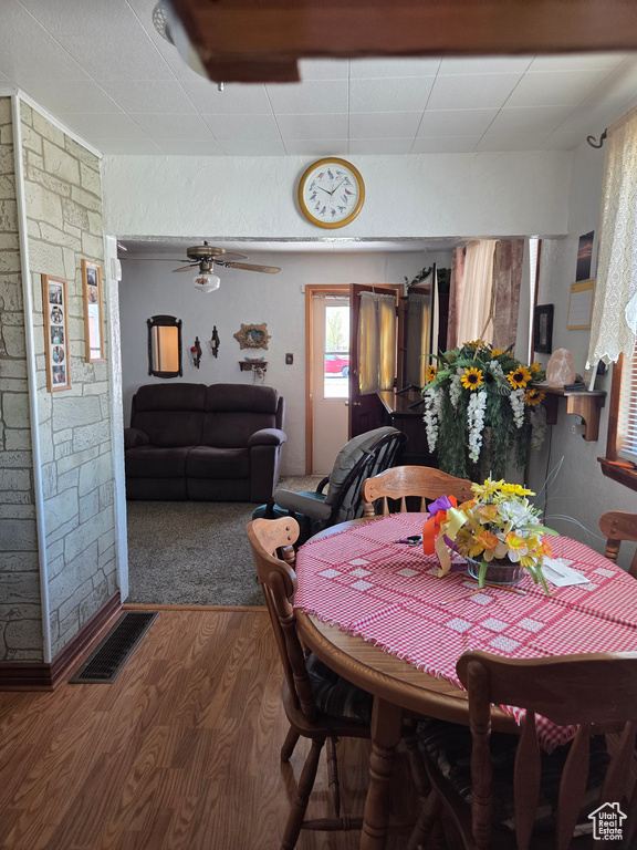 Dining area featuring wood finished floors and ceiling fan