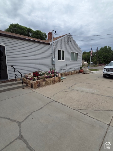 Rear view of house featuring a chimney