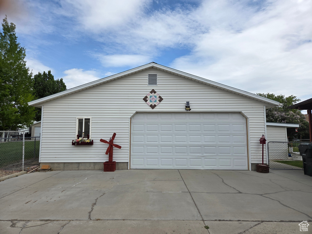 Detached garage featuring fence