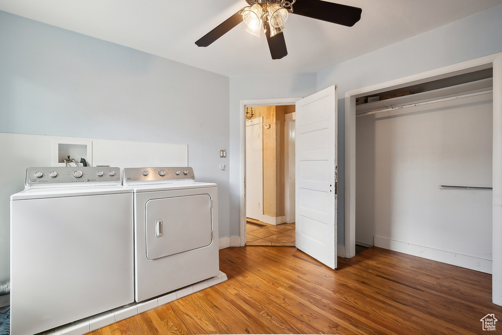 Washroom featuring independent washer and dryer, a ceiling fan, and light wood-type flooring