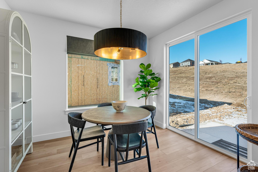Dining area with light wood-style floors and baseboards