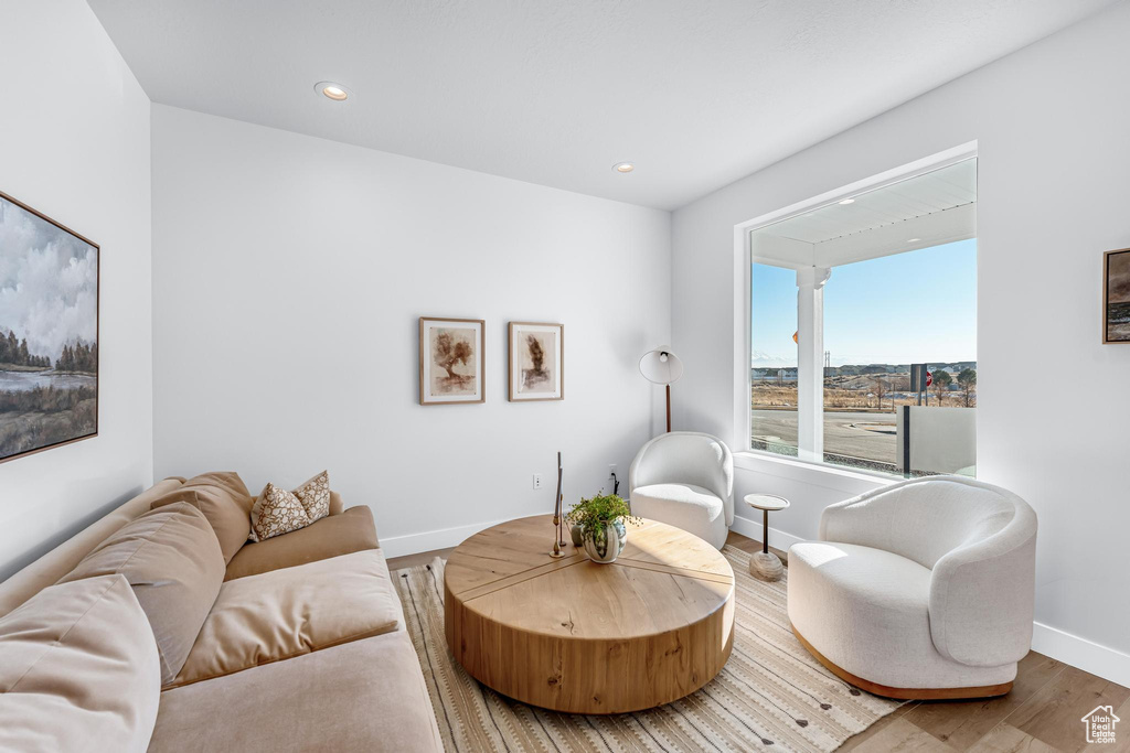 Living area featuring baseboards, wood finished floors, and recessed lighting
