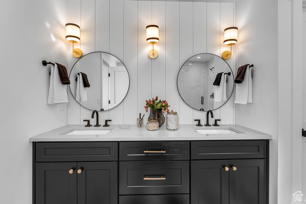 Bathroom featuring double vanity and a shower