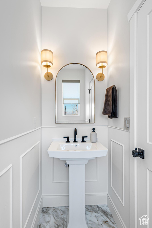 Bathroom featuring marble finish floors and baseboards