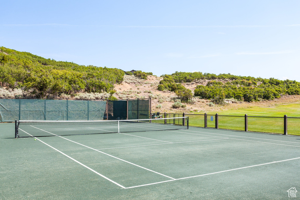 View of tennis court with fence