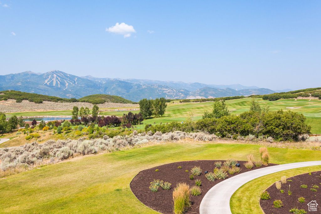 View of mountain backdrop with a local golf course and a nearby body of water