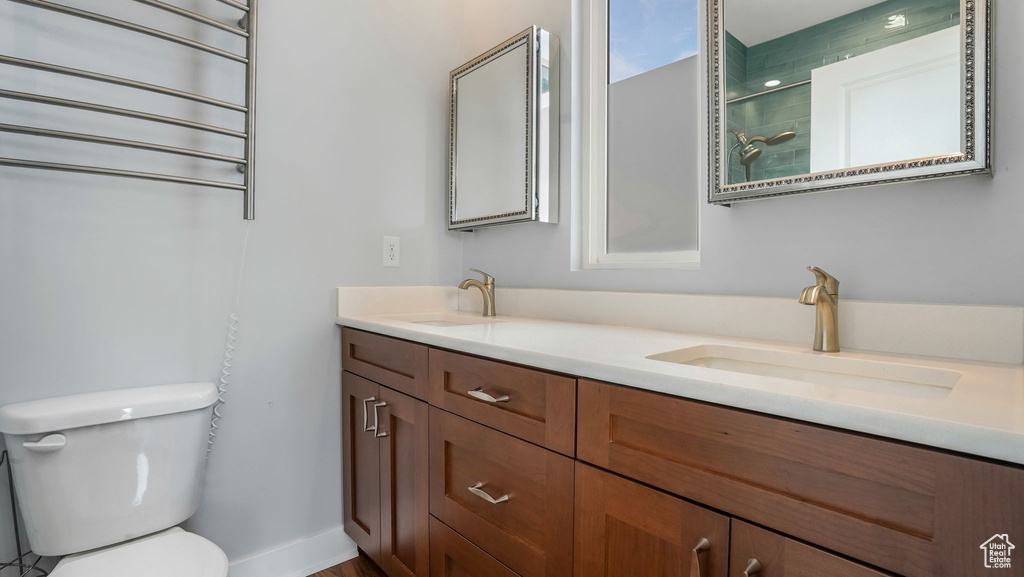 Bathroom featuring toilet and double vanity