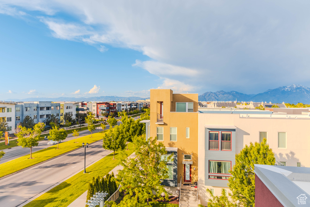 View of front of house featuring stucco siding, a mountain view, and a residential view