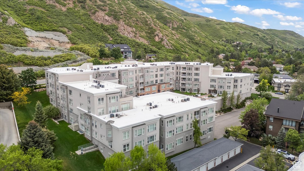 Aerial view of a mountainous background and apartment complex / building