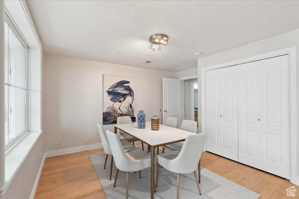 Dining space with light wood-type flooring and baseboards