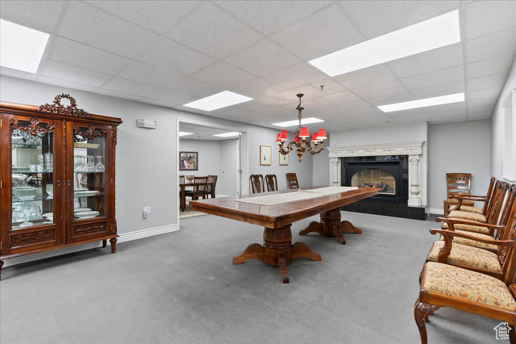 Playroom featuring carpet, a tile fireplace, a paneled ceiling, and baseboards